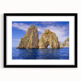 Colorful abstract art print of Capri, Italy in a large black frame, featuring vibrant, textured hues.
