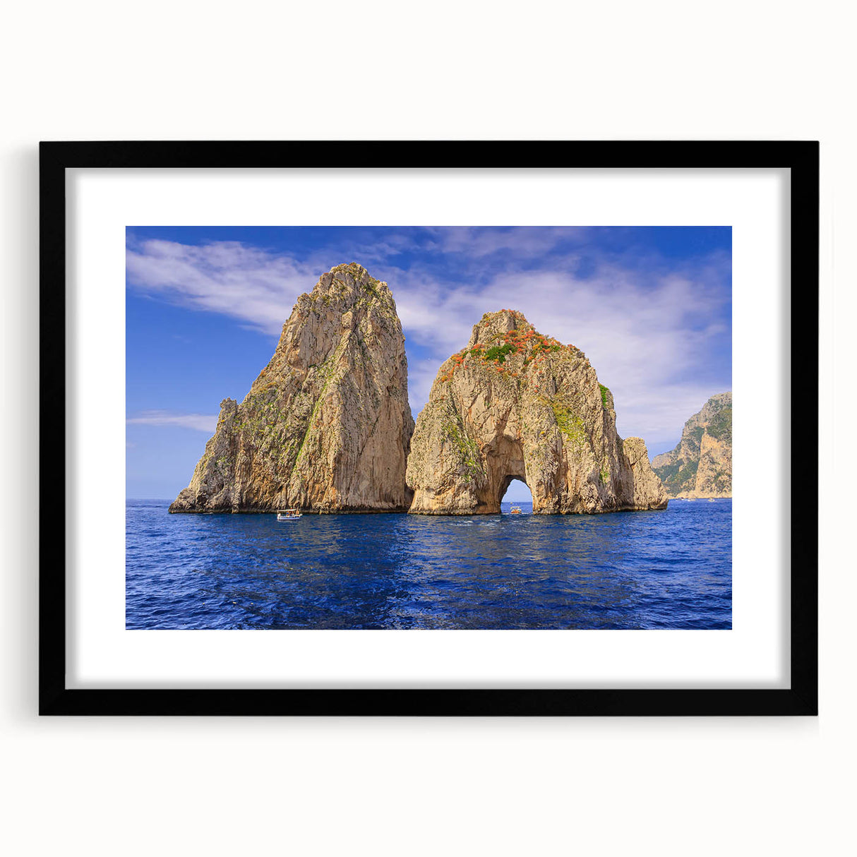 Colorful abstract art print of Capri, Italy in a large black frame, featuring vibrant, textured hues.