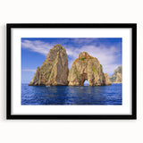 Colorful abstract art print of Capri, Italy in a large black frame, featuring vibrant, textured hues.