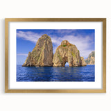 Abstract art print of Capri, Italy in muted blue and gold tones on a framed canvas, suitable for dining room decor.