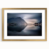 Abstract art print of Lake Como with muted blue and green tones on a framed gold mat, ideal for dining room decor.