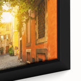 Close-up of a black framed canvas depicting a textured scene of Rome, Italy, with vibrant color accents.