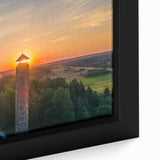 Close-up of a black framed canvas featuring a textured, colorful Lithuanian landscape, ideal for living room decor.