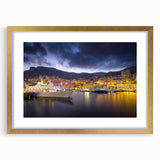 Abstract art print of Monaco scenery in muted gold and blue tones on a framed canvas, suitable for dining room decor.