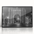Large abstract wall art depicting a stylized Barcelona cityscape in muted gray and blue tones, framed in black acrylic.