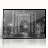 Large abstract wall art depicting a stylized Barcelona cityscape in muted gray and blue tones, framed in black acrylic.