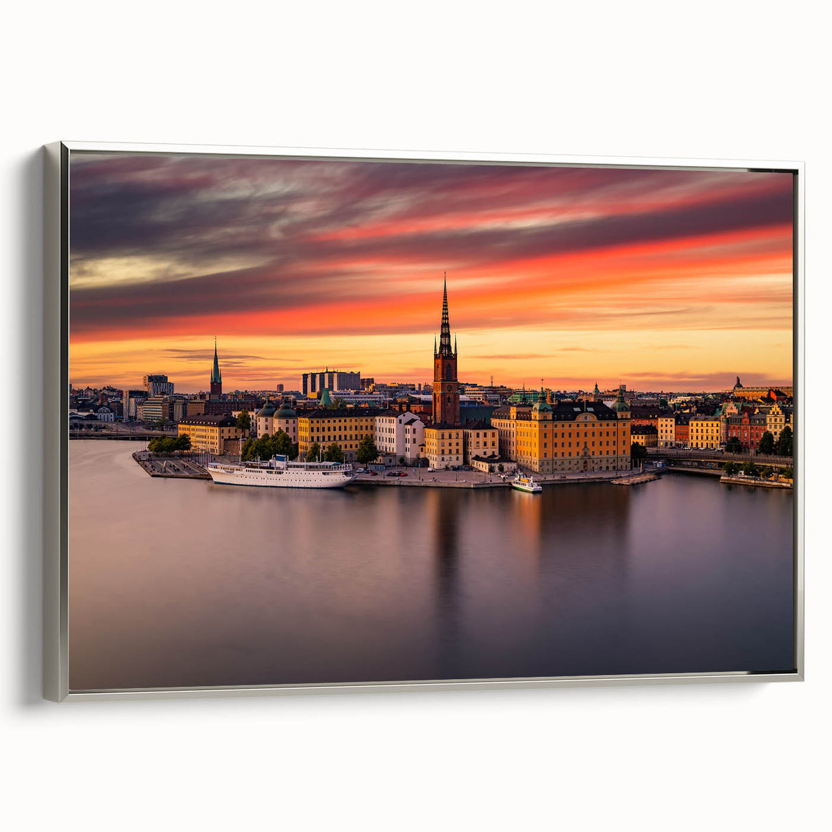 Framed canvas landscape art painting of Stockholm featuring colorful buildings and water, set in a silver frame.