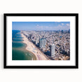 Extra large abstract art print of Tel Aviv skyline in vibrant, colorful hues on a textured canvas, framed with a black mat.