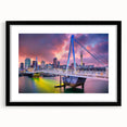Abstract art print of Auckland skyline with vibrant, colorful textures on a large black-framed canvas.