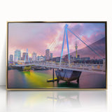 Acrylic print of Auckland skyline in muted gold and blue hues, framed in gold, ideal for modern art wall decor.