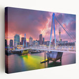 Large art print of Auckland's skyline on stretched canvas, featuring muted blues and greens, ideal for kitchen wall decor.