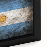 Close-up of a black wall art canvas depicting a colorful, textured scene of a South American landscape.