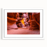Abstract art print of Antelope Canyon in Arizona, featuring swirling orange and red rock formations, framed in white.