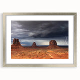Textured art print of Monument Valley in muted earth tones on a framed canvas, suitable for bedroom decor.