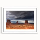 Abstract art print of Monument Valley in muted earth tones on a framed white mat, suitable for bedroom or dining room decor.