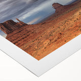 Art deco poster of Monument Valley in vibrant orange and red tones on rolled canvas, suitable for dining room wall art.