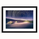 Abstract art print of Death Valley in colorful, textured tones on a large black-framed canvas, ideal for living room decor.