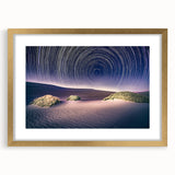 Extra large abstract art print depicting Death Valley, in muted earth tones on a textured canvas, framed in gold.