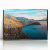 Mid-century modernist art depicting Lake Tahoe with muted blue and green tones on a silver-framed acrylic print.