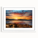 Abstract art print of the Rocky Mountains in muted blue and gray tones on a framed white mat, ideal for dining room decor.