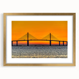 Extra large abstract art print depicting the Tampa skyline in vibrant blues and oranges, framed in gold.