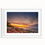 Abstract art print of Acadia's rugged coastline in muted blue and gray tones, framed with a white mat.