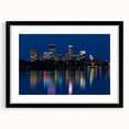 Extra large abstract art print of Minneapolis skyline in textured tones of blue and gray, framed with a black mat.