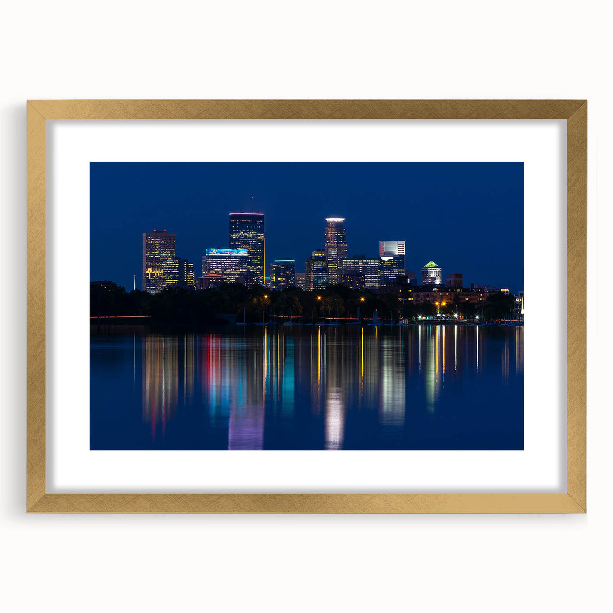 Colorful abstract art print of Minneapolis skyline on a textured canvas, framed in gold.