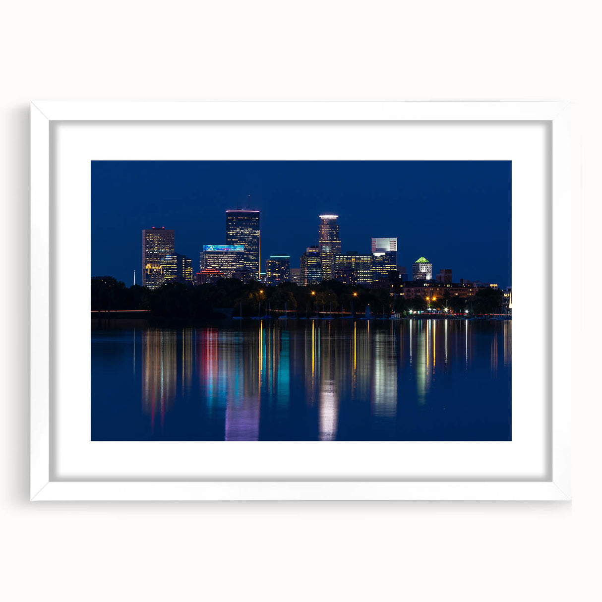 Abstract art print of Minneapolis skyline in muted gray and blue tones, framed with a white mat.