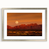 Textured abstract art print of New Mexico scenery in muted earth tones, framed with a silver mat, suitable for bedroom decor.