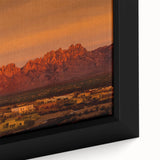 Close-up of a textured black wall art depicting a New Mexico scenery in vibrant colors on a framed canvas.