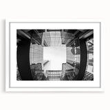 Abstract art print of Charlotte skyline in muted gray and blue tones on a framed white mat.