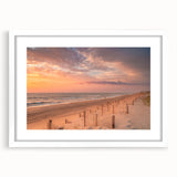 Abstract art print of the Outer Banks in muted blue and green tones, framed in white, ideal for dining room decor.
