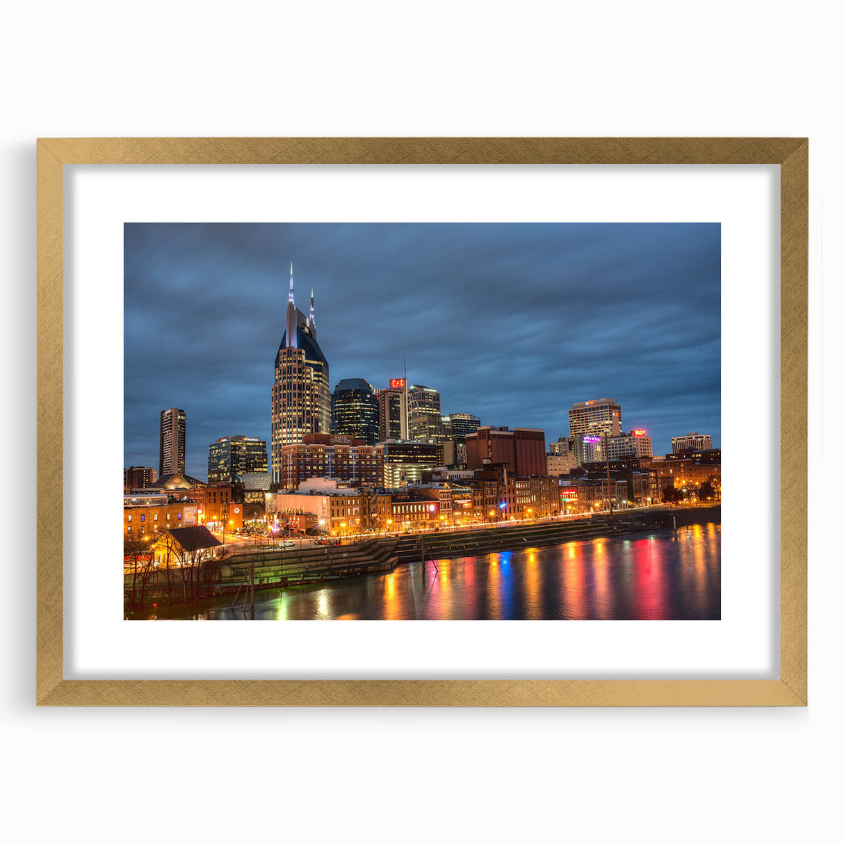 Abstract art print of Nashville skyline in muted gold and blue tones on a large framed canvas.