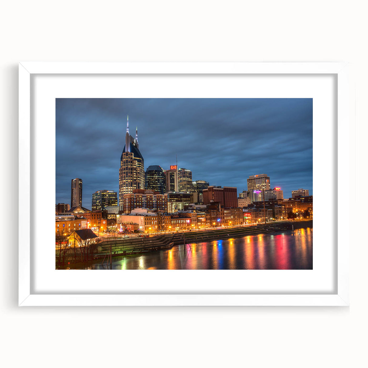 Abstract art print of Nashville skyline in muted gray and blue tones on a framed white mat, ideal for dining room decor.
