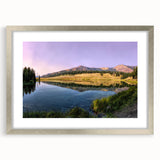 Textured abstract art print of Yellowstone scenery in muted earth tones, framed in silver, suitable for bedroom decor.