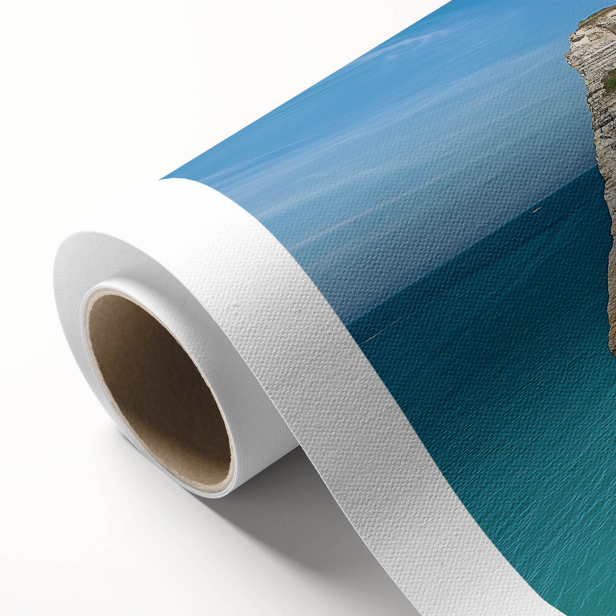 Stunning rolled canvas print showcasing a vibrant landscape of dramatic cliffs under a bright blue sky, perfect for home decor and art enthusiasts, packaged securely in a protective tube.
