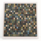 Abstract geometric canvas art featuring vibrant colors and sharp lines, ideal for modern home decor, leaning against a neutral wall for display.