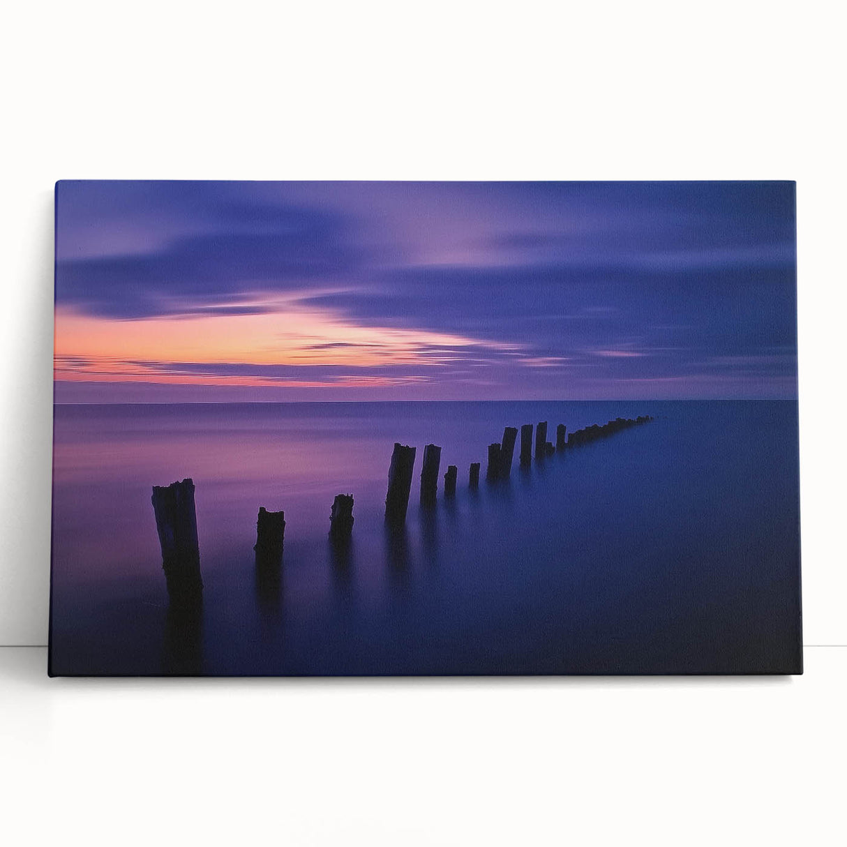 Stretched canvas artwork showcasing a serene beach landscape, featuring soft hues of blue and beige, perfect for home decor or coastal-themed interiors.