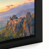 Framed canvas artwork depicting a serene countryside landscape, showcasing vibrant greens and soft blues, perfect for home decor. The piece captures the essence of nature's tranquility.