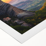 Rolled canvas print depicting a serene countryside landscape with rolling hills and vibrant greenery, elegantly packaged in a protective cardboard tube for safe delivery.
