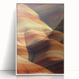 Framed acrylic artwork showcasing a vibrant desert landscape with orange and yellow hues, displayed in a sleek white frame, perfect for modern decor.