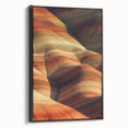 Framed canvas artwork depicting a vibrant desert landscape with warm earth tones, showcased in a sleek black frame, ideal for home decor and art enthusiasts.