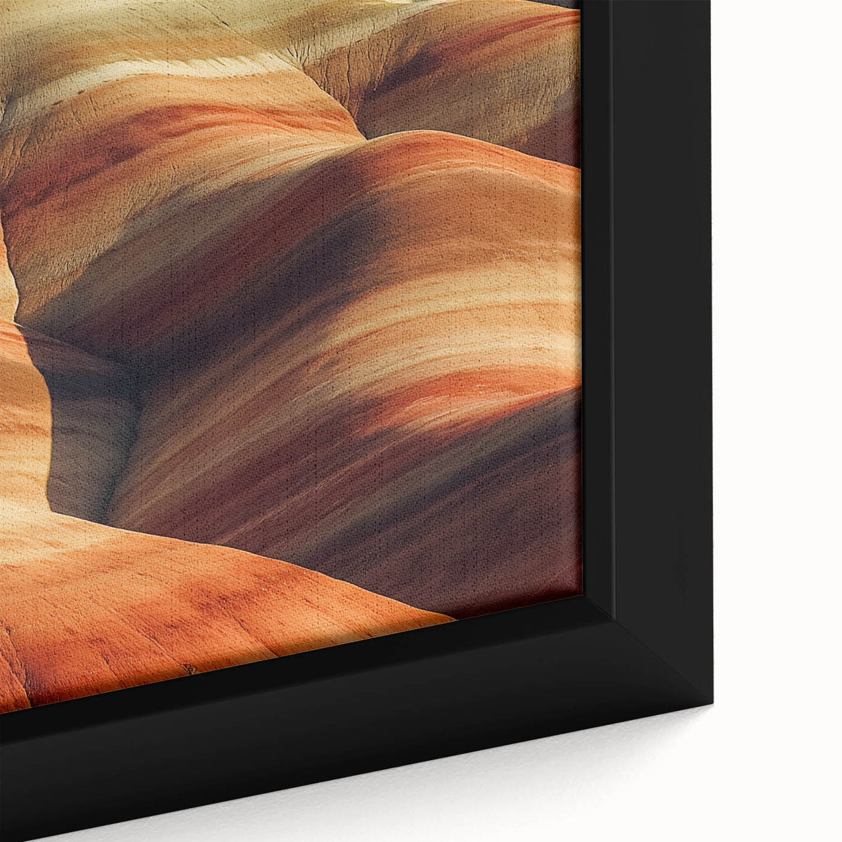 Close-up of a framed canvas showcasing a vibrant desert landscape, featuring warm tones of orange and yellow with intricate details of dunes and a clear blue sky, perfect for home decor or art enthusiasts.