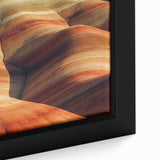 Close-up of a framed canvas showcasing a vibrant desert landscape, featuring warm tones of orange and yellow with intricate details of dunes and a clear blue sky, perfect for home decor or art enthusiasts.