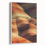 Framed canvas artwork showcasing a vibrant desert landscape with warm tones of orange and yellow, presented in a sleek white frame, ideal for home décor.