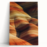 Stretched canvas artwork depicting a vibrant desert landscape, featuring warm hues of orange and yellow with textured brushstrokes, ideal for home decor enthusiasts.