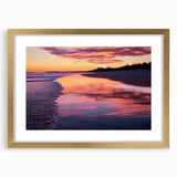 Elegant landscape artwork depicting serene beaches, framed with a gold mat, showcasing vibrant blues and soft sandy hues, perfect for home decor.