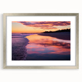 Silver-framed landscape wall art featuring a serene beach scene with soft waves, vibrant sky, and elegant matting, ideal for coastal-themed decor.