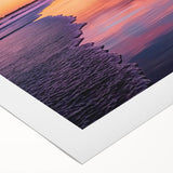 Rolled canvas artwork showcasing a serene beach landscape with vibrant colors and soft waves, elegantly packaged in a protective cardboard tube for safe shipping.